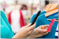 apparel close up woman shopping looking at tag on shirt
