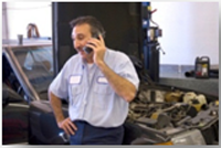 autoparts mechanic on the phone in an autoshop