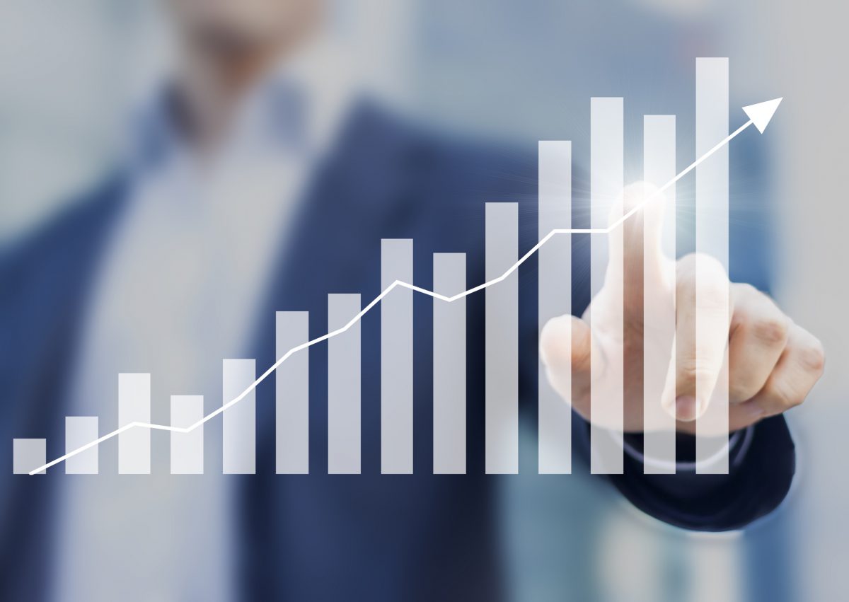 Man pointing to graph chart showing increase over time