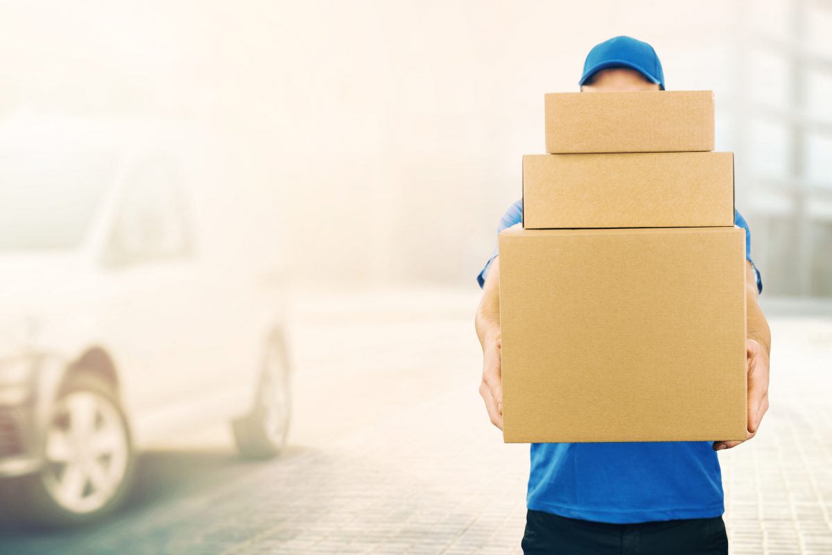 Delivery man holding 3 boxes