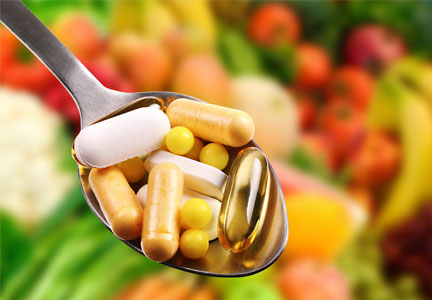 InterHealthPills_Embedded bright pills on spoon with blurred pills in the background