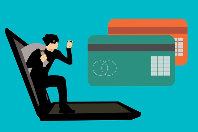 animated thief coming out of computer with flashlight shining on credit cards