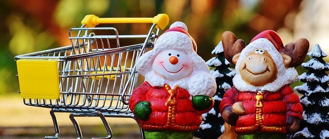 snowman and reindeer ornaments next to shopping cart