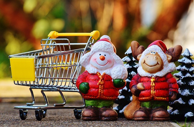 snowman and reindeer ornaments next to shopping cart