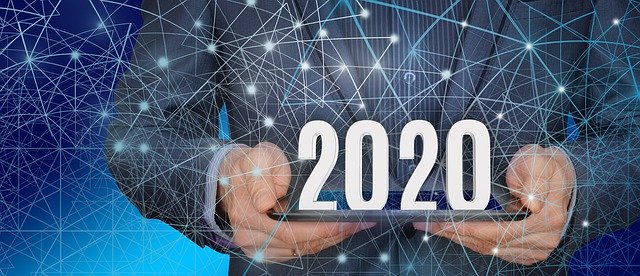 man in suit holding 2020 with data points overlay