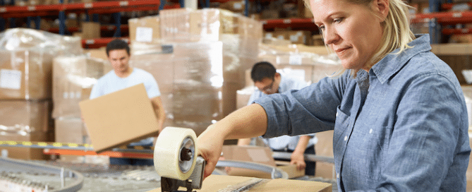 woman shipping packages in warehouse